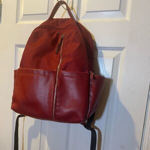 Tutilo Synthetic leather & Nylon Red padded Backpack gold tone hardwares .